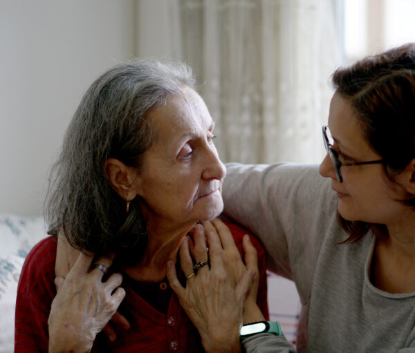 Woman hugging her elderly mother